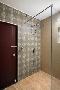 a bathroom with a shower with a glass door at Coffee Bean Inn in Bangalore +40 photos