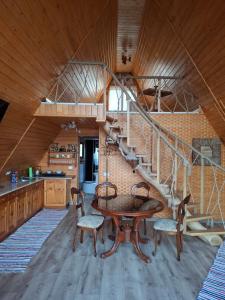 a spiral staircase in a kitchen with a table and chairs at A frame iris in Filioara
