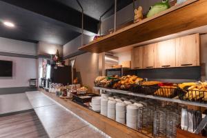a kitchen with a counter with baskets of food at Hotel Ibis Budget Fecamp in Fécamp