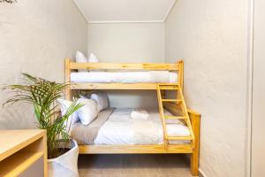 a room with two bunk beds and a plant at Beach Bliss Pad in Ballito