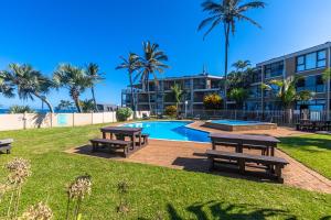 a park with picnic tables and a swimming pool at Beach Bliss Pad in Ballito