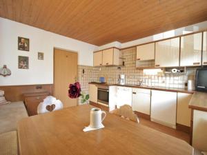 a kitchen with a wooden table in a room at Chalet Gamper by Summit Travel in Ellmau