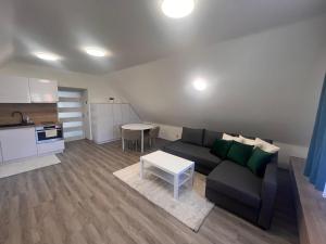 a living room with a couch and a table at Ulrichova vila a Vilka Rejhotice in Šumperk