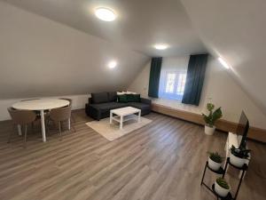 a living room with a couch and a table at Ulrichova vila a Vilka Rejhotice in Šumperk