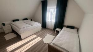 a small bedroom with two beds and a window at Ulrichova vila a Vilka Rejhotice in Šumperk +242 photos