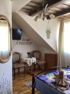 a bedroom with a bed and a table and chairs at Margaréta Panzió in Sárospatak +87 photos