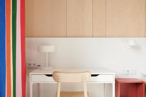 a white desk with a chair in a room at IKEA Hotell in Älmhult
