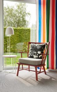 a chair sitting in a room with a window at IKEA Hotell in Älmhult