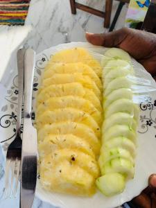 a plate of food with pineapple and bananas on it at SaitotiMara Safaris in Sekenani