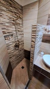 a bathroom with a shower and a sink at Margaréta Panzió in Sárospatak