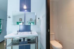 a bathroom with a sink and a toilet at Hostel El Castillo in Aniñon +10 photos