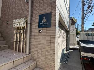a building with a sign on the side of it at Shibuya City House 渋谷シティハウス in Tokyo