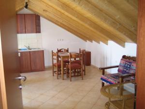 a kitchen and dining room with a table and chairs at Vegera Apartments in Vasilikiádhes