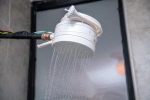 a shower head with water coming out of it at Kanotis place in Ongata Rongai 
