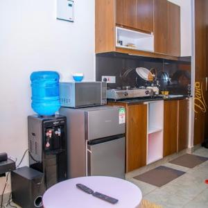 a kitchen with a microwave and a table in it at Kanotis place in Ongata Rongai 