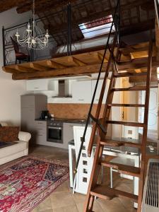 a loft bed in a room with a kitchen at Agriturismo Villa Anconetta in Loreo