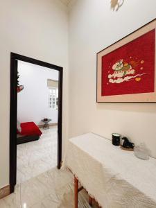 a room with a table and a picture on the wall at Mya's Homestay in Long Trường
