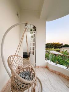 a swinging chair in a room with a window at Mya's Homestay in Long Trường