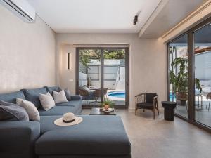 a living room with a blue couch and a table at Grand Residences in Chania
