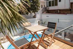 a wooden table and two chairs on a balcony at Grand Residences in Chania