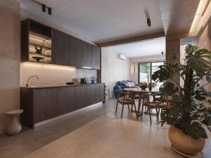 a kitchen and dining room with a table and a plant at Grand Residences in Chania +82 photos