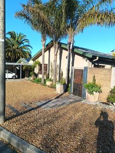 a house with palm trees in front of a driveway at Danlavie in Tyger Valley
