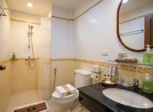 a bathroom with a toilet and a sink and a mirror at Chaba silom in Bang Rak +6 photos