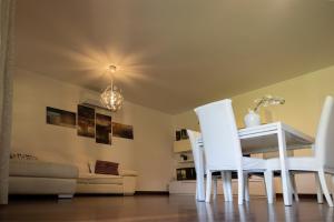 a dining room with a white table and white chairs at Villa Libo - HelloElba in Marciana Marina