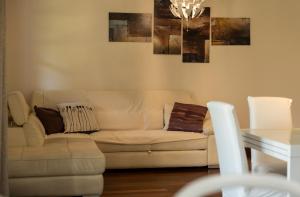 a living room with a white couch and a table at Villa Libo - HelloElba in Marciana Marina