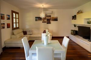 a living room with a table and a couch at Villa Libo - HelloElba in Marciana Marina +27 photos