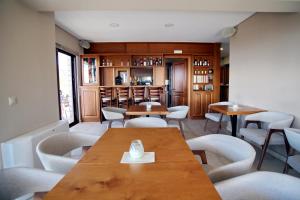 a restaurant with tables and chairs and a bar at Treanto Nafpaktos Boutique Hotel in Nafpaktos