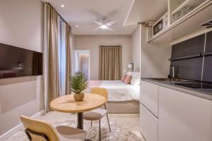 a room with a bed and a small table with chairs at NORFOLK Suites in Sliema