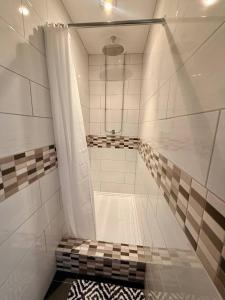 a bathroom with a shower with a shower curtain at Spacious House Sleeps 10 -Near BikePark Wales -Central -Parking in Troed-y-rhiw +25 photos