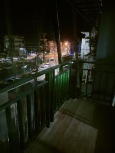 a balcony with a view of a city at night at Pailin Daily F2 in Phetchabun
