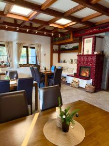 a living room with a table and a fireplace at Jezírko lesní restaurant & penzion in Jáchymov