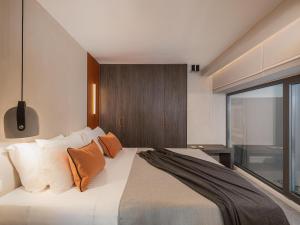 a bedroom with a large bed with orange pillows at Grand Residences in Chania
