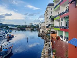 a river between two buildings with boats in it at Hotel View Sông Phú Quốc in Phú Quốc