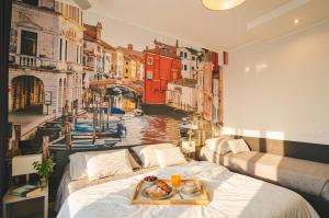 a room with two beds with a painting of a canal at Hotel Park in Sottomarina