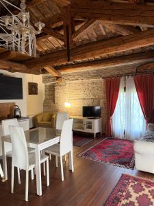 a living room with a table and chairs and a couch at Agriturismo Villa Anconetta in Loreo