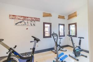 a gym with three exercise bikes in a room at Hostel El Castillo in Aniñon