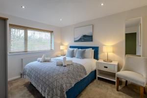 a bedroom with a large bed and a chair at Newhaven in Telford