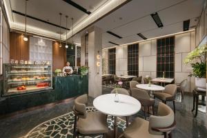 a restaurant with tables and chairs and a counter at Hong Ngoc Cochinchine Boutique Hotel & Spa in Hanoi