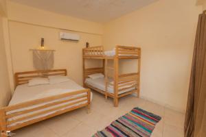a bedroom with two bunk beds and a rug at The Sea side camp nuweiba in Nuweiba