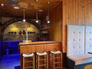 a bar with stools and a counter in a restaurant at CARIBBEAN Home in Montcada i Reixac
