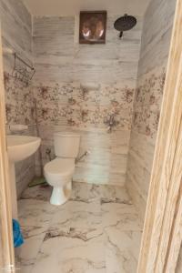 a bathroom with a toilet and a sink at The Sea side camp nuweiba in Nuweiba