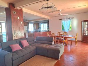 a living room with a couch and a table at Villa Dijoux D'O in Entre-Deux