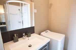 a bathroom with a sink and a toilet and a mirror at Central View, Hossegor, Plage, Famille in Hossegor +11 photos