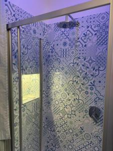 a shower with a glass door in a bathroom at Vietri House 88 in Vietri sul Mare