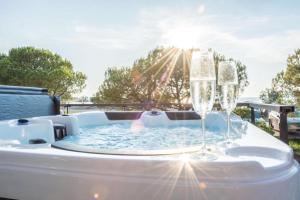 a hot tub with two glasses of champagne at Floating house - Marina Relax in Portorož +56 photos