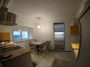 a kitchen and dining room with a table and a kitchen and a room at Juwel in San Lorenzo in Genoa
